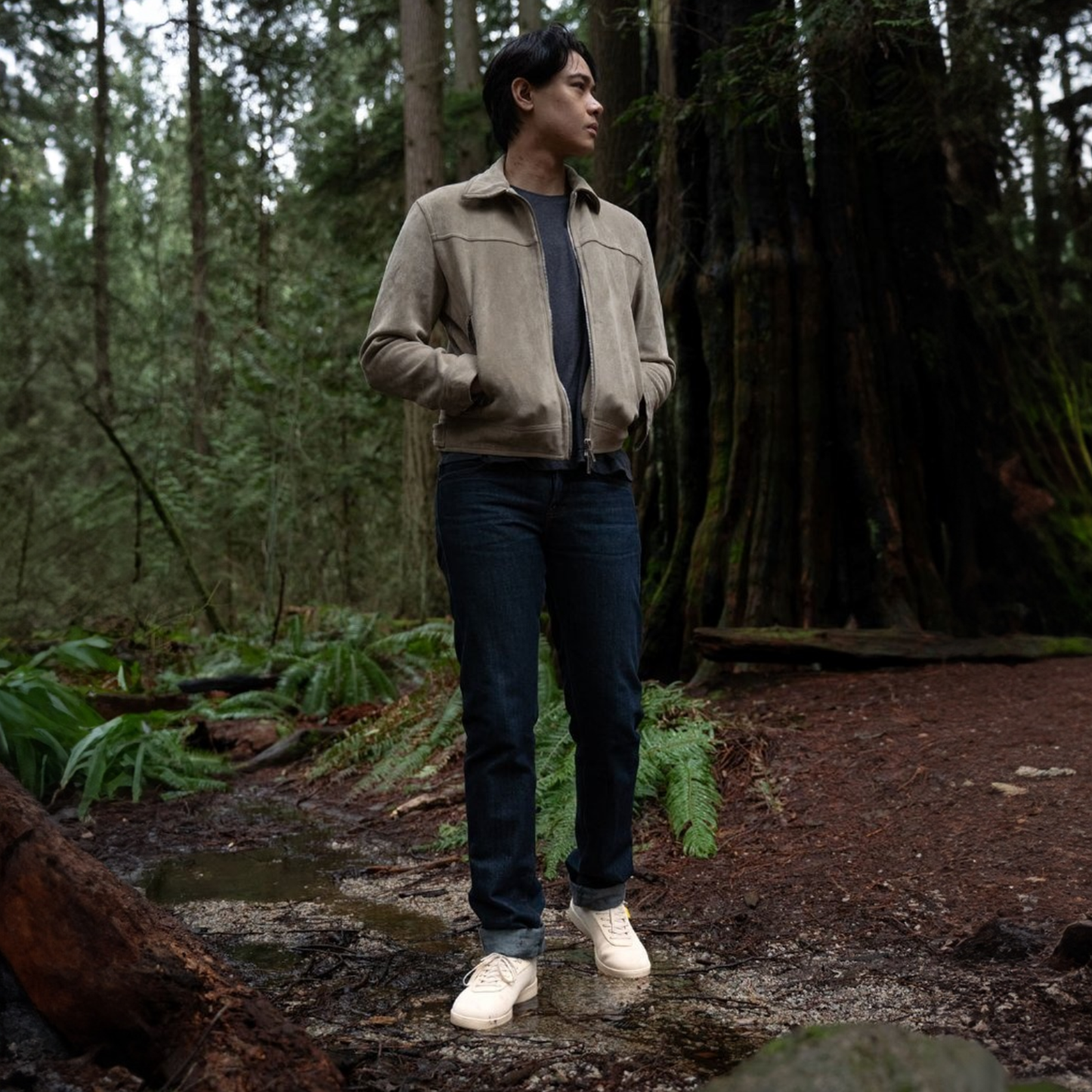Man standing in a forest wearing a beige waterproof shoe