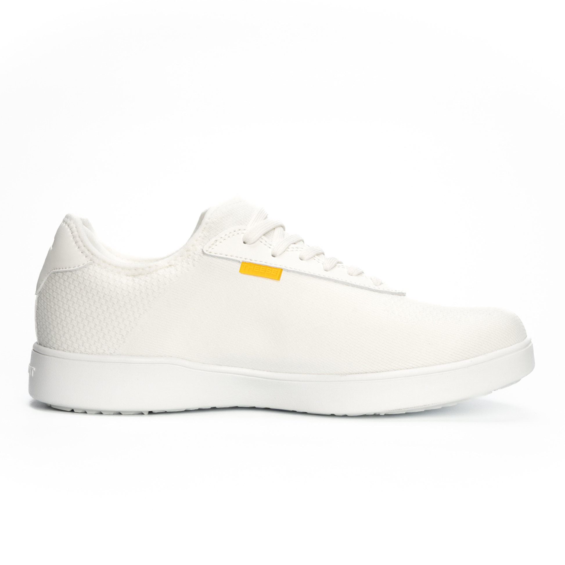 White sneaker with a small yellow tag on a white background