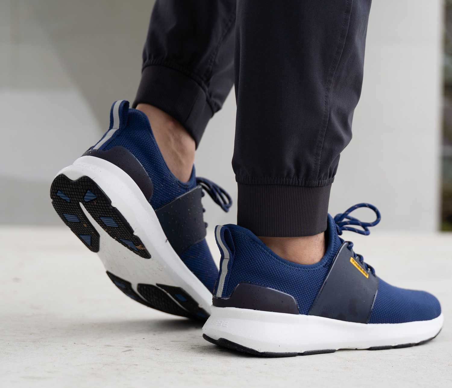 person standing with flow state royal blue waterproof shoes