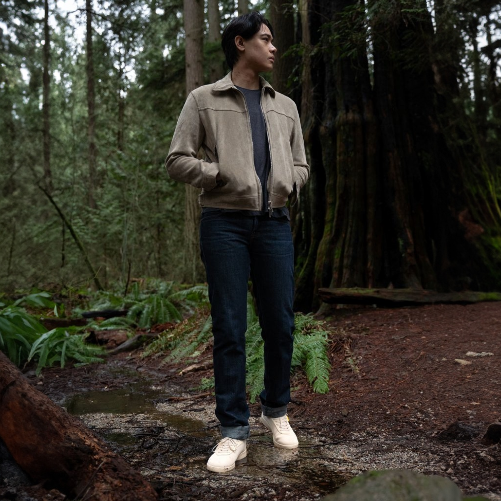 Man standing in a forest wearing a beige waterproof shoe